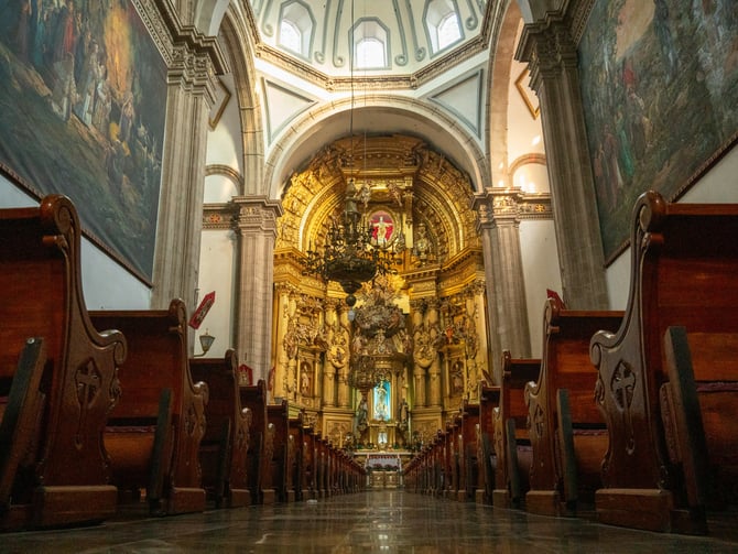 Ornate church interior with murals and wooden pews